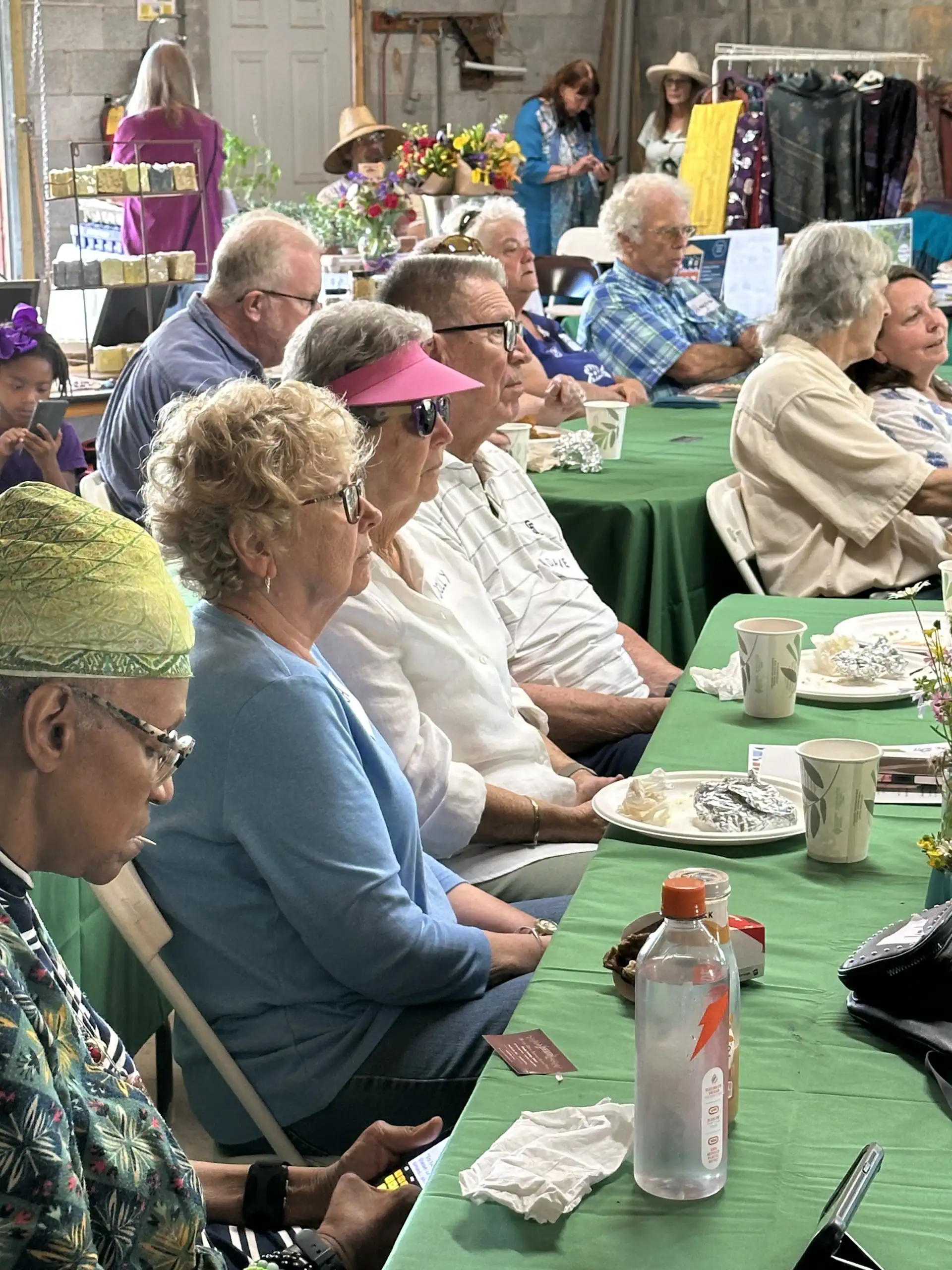 Down to Earth Fair attendees pack the equipment barn at Whispering Hills for lunch-and-learn presentations and exhibits