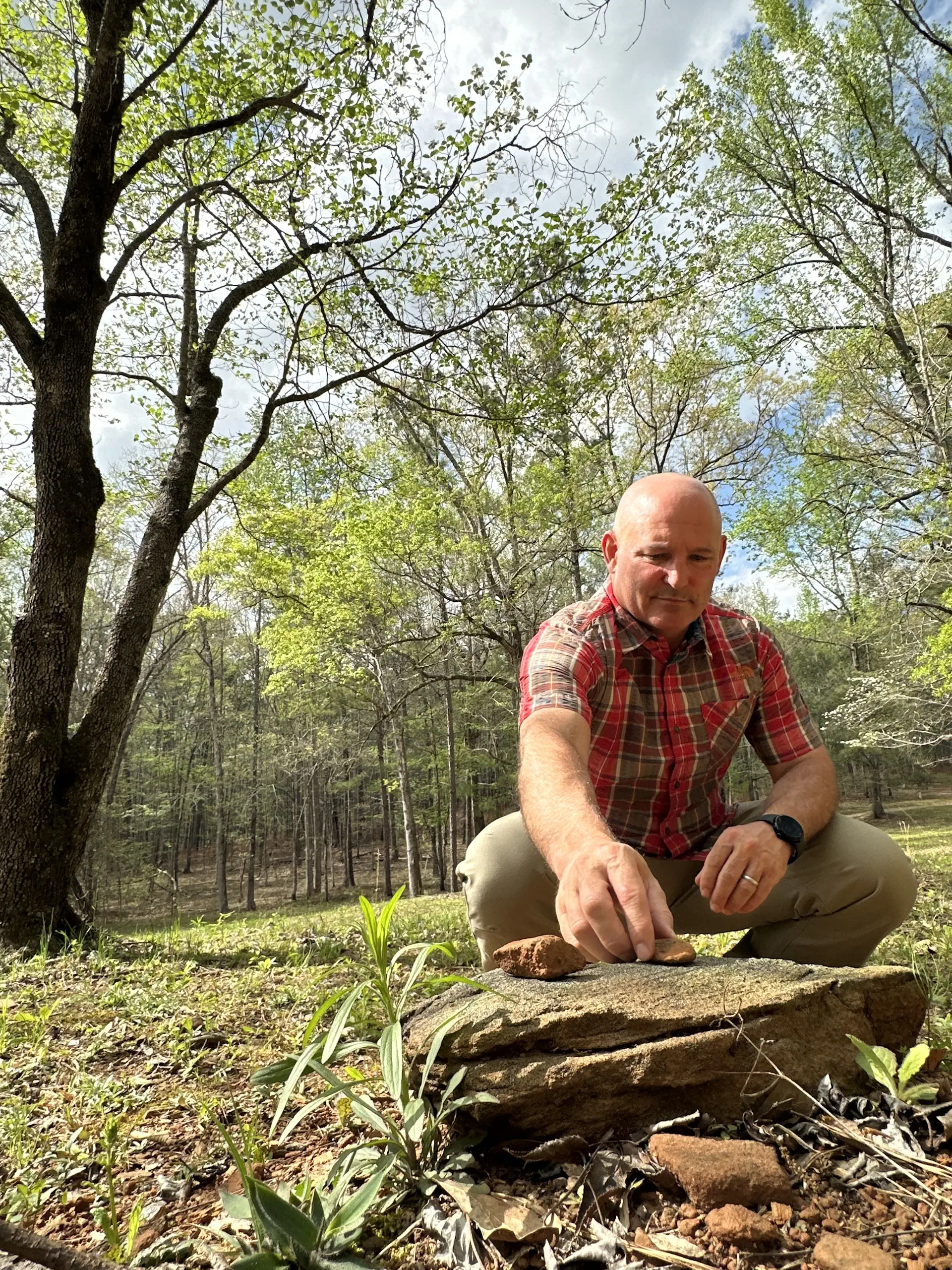 Jeff Martin places a symbolic birthday stone atop the tribute stone that marks his mothers grave at Whispering Hills