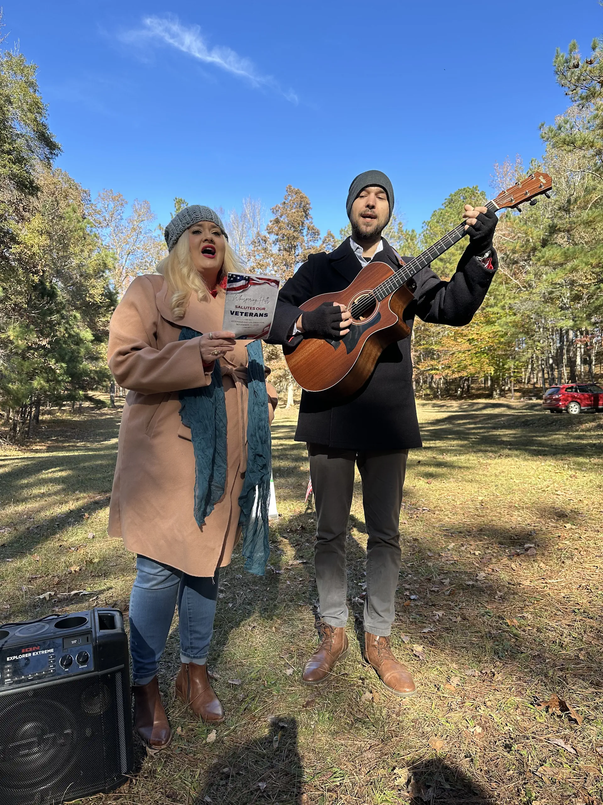 Anna and Nick Mayfield lead the group sing of America at Whispering Hills Veterans Day celebration