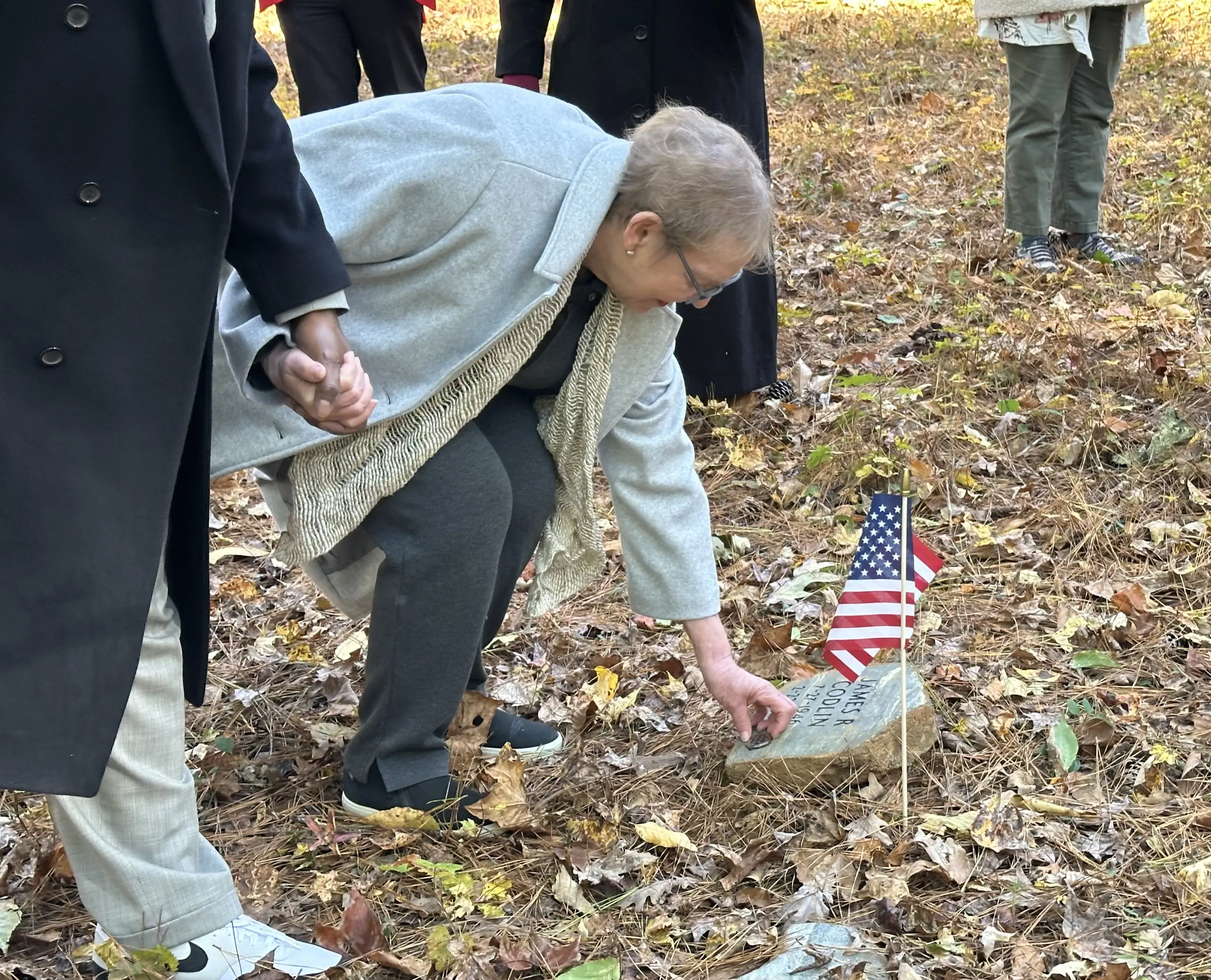Terri Codlin places Air Force service medallion on her husband Jim’s tribute stone at Whispering Hills
