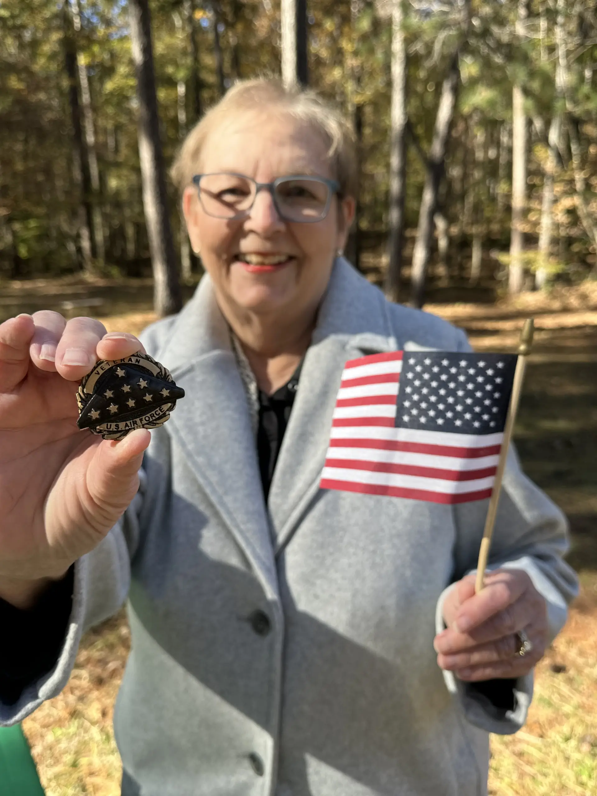 Terri Codlin holds up her husband Jim’s Air Force service medallion